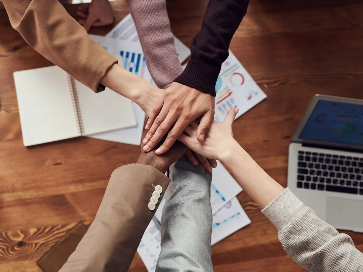 Care team members joining hands